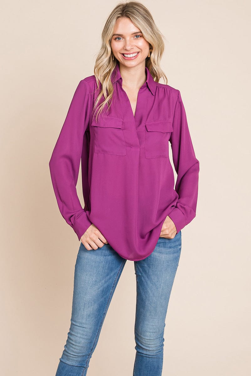 A stylish V neck collared blouse with two front pockets, featuring long sleeves and a button front, displayed on a mannequin.