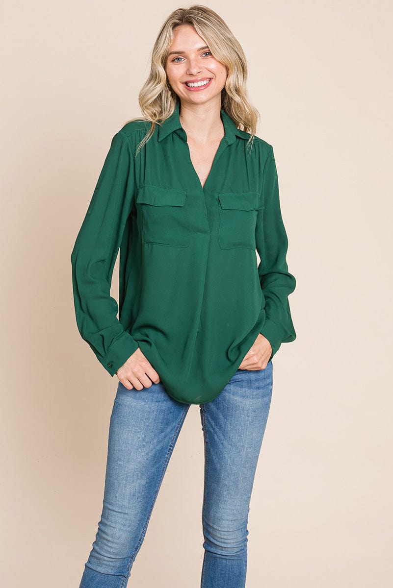 A stylish V neck collared blouse with two front pockets, featuring long sleeves and a button front, displayed on a mannequin.