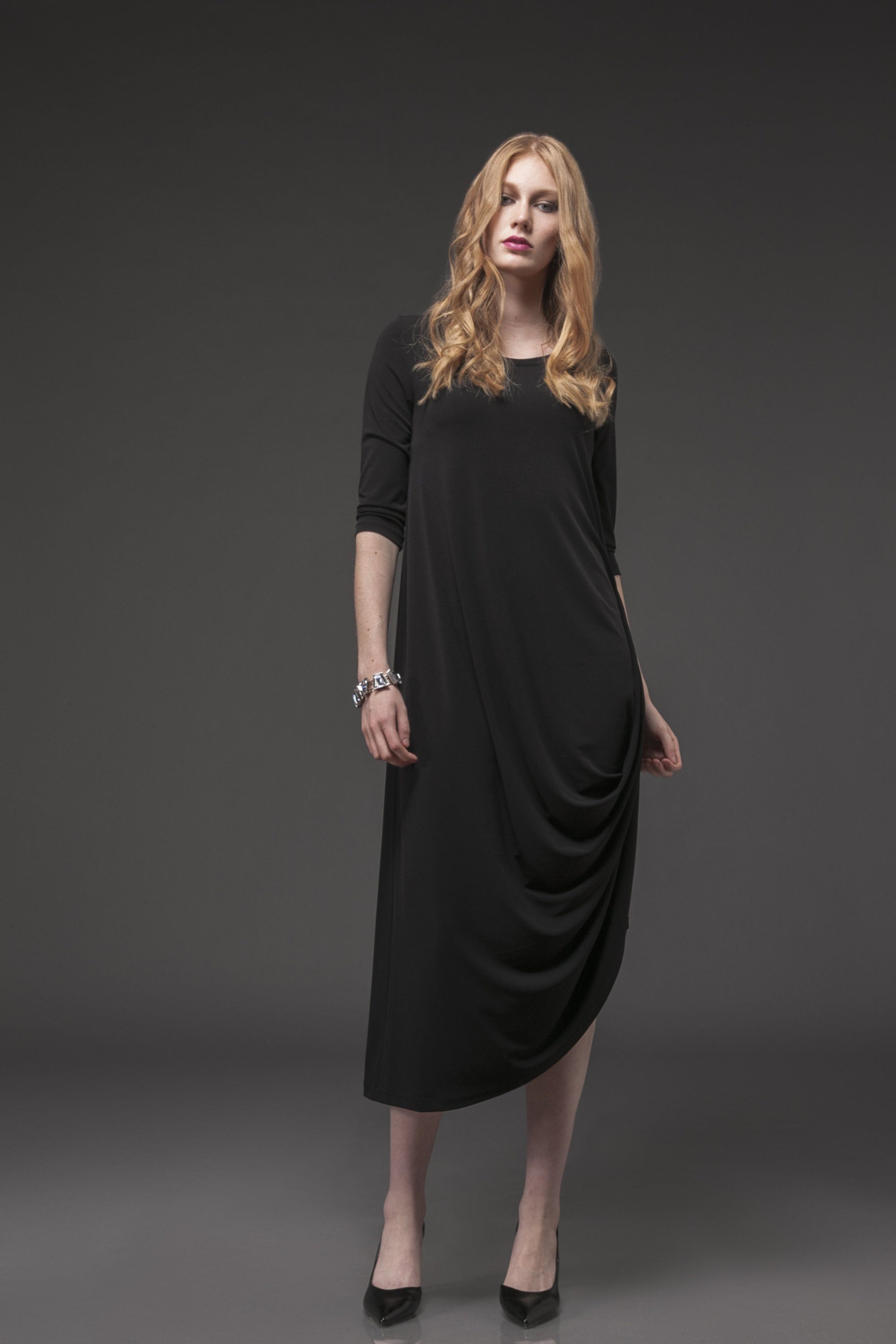 A stylish woman wearing the elegant Versailles Dress, showcasing its flattering fit and versatile design.