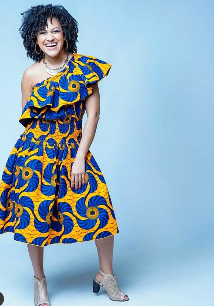 A stylish woman wearing a Versatile Off Shoulder Ankara Dress, showcasing vibrant patterns and a chic off-shoulder design.