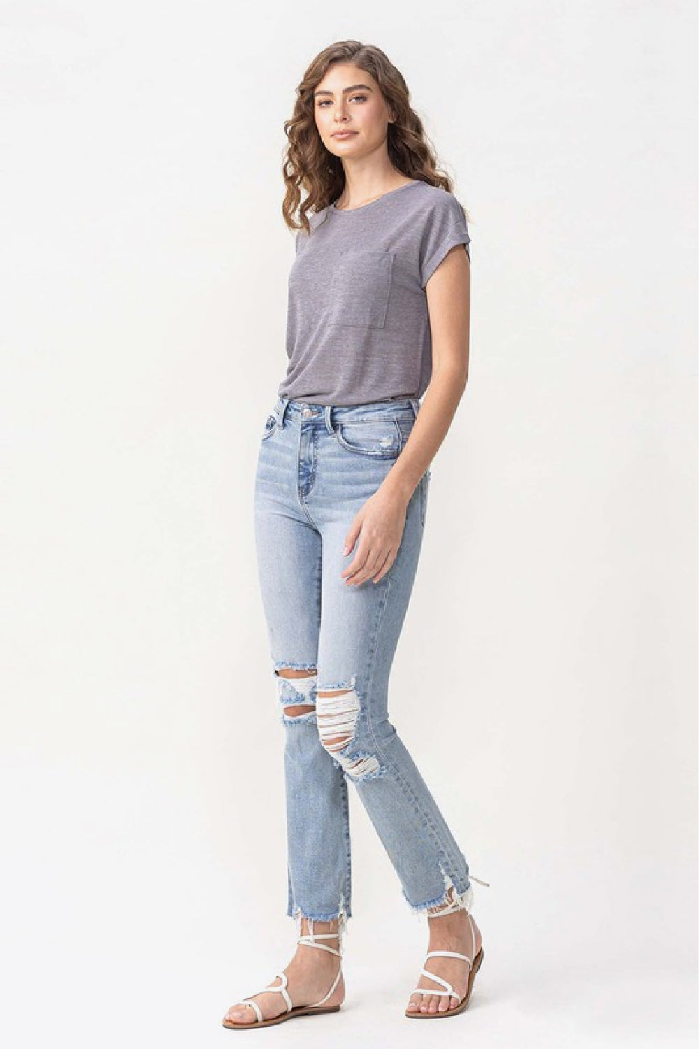 Vervet Wren Full Size High Rise Crop Flare Jeans featuring distressed knees and hems, light-wash denim, and a cropped length.