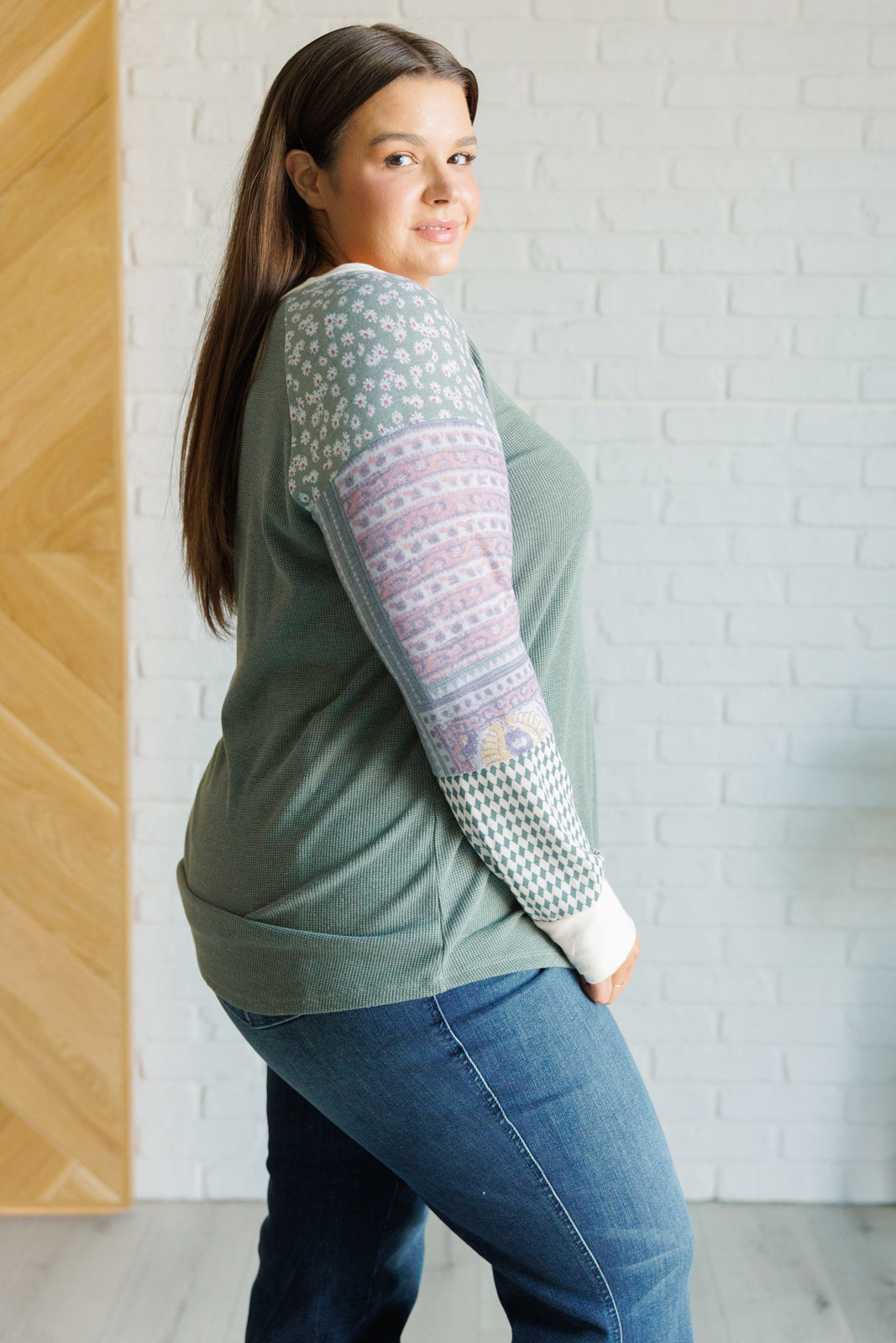 A stylish Very Curious Mixed Print Top featuring a waffle knit bodice and floral raglan sleeves, perfect for casual wear.