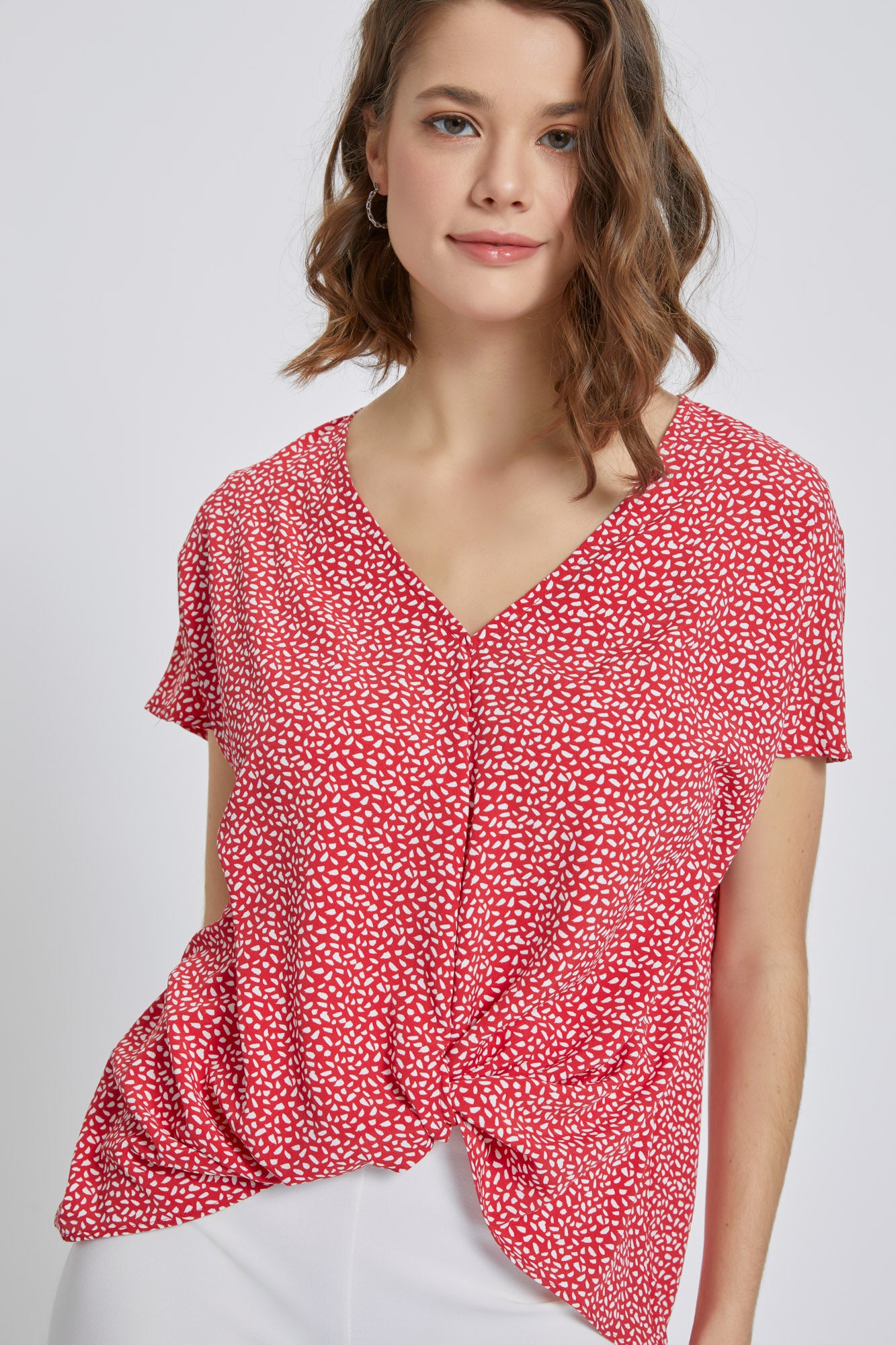 A stylish V-Neck Short Sleeve Wrap Front Top for Women featuring a knot detail at the waist, perfect for casual or dressy occasions.