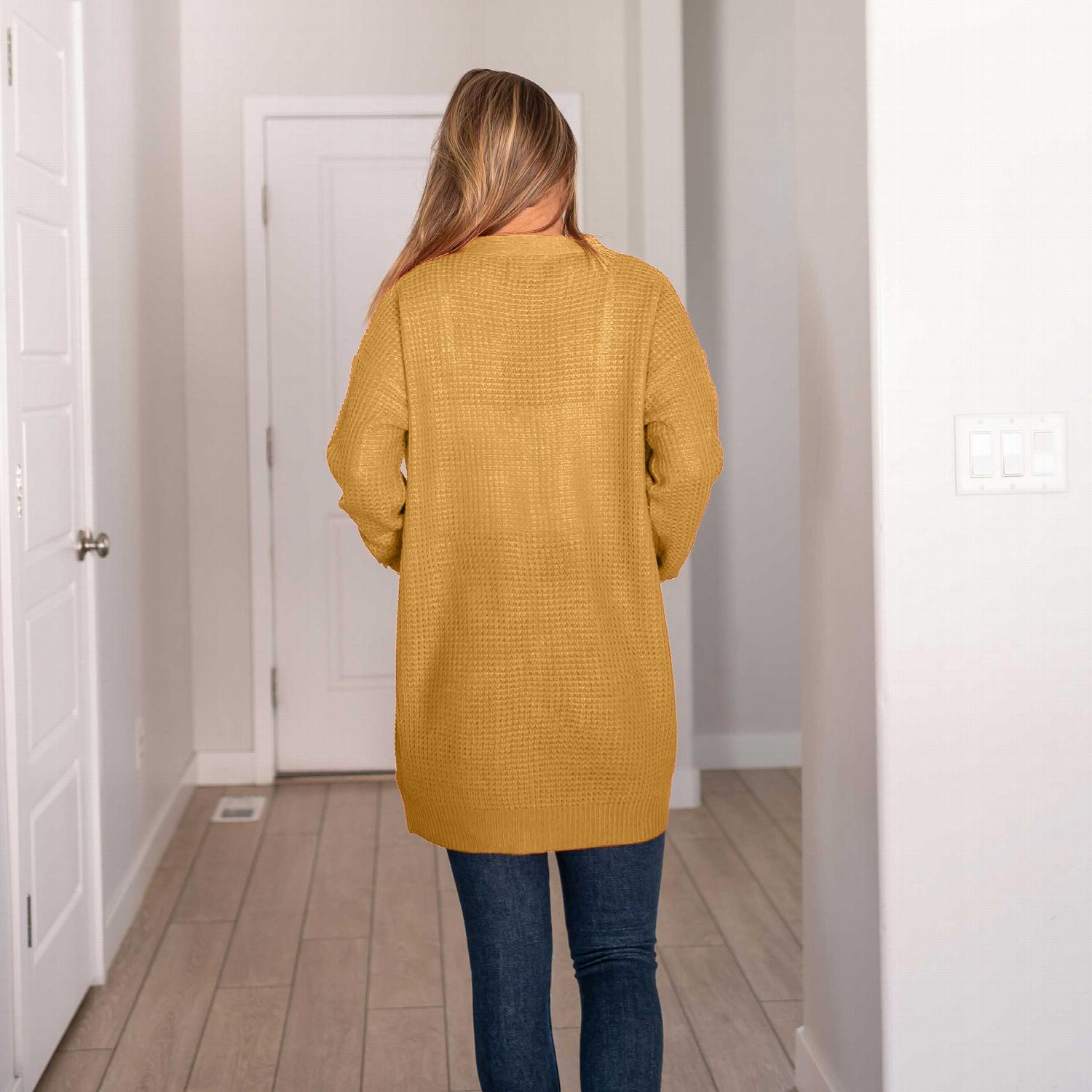 Waffle knit pocketed long sleeve cardigan sweater in a stylish open front design, featuring large pockets and a relaxed fit.