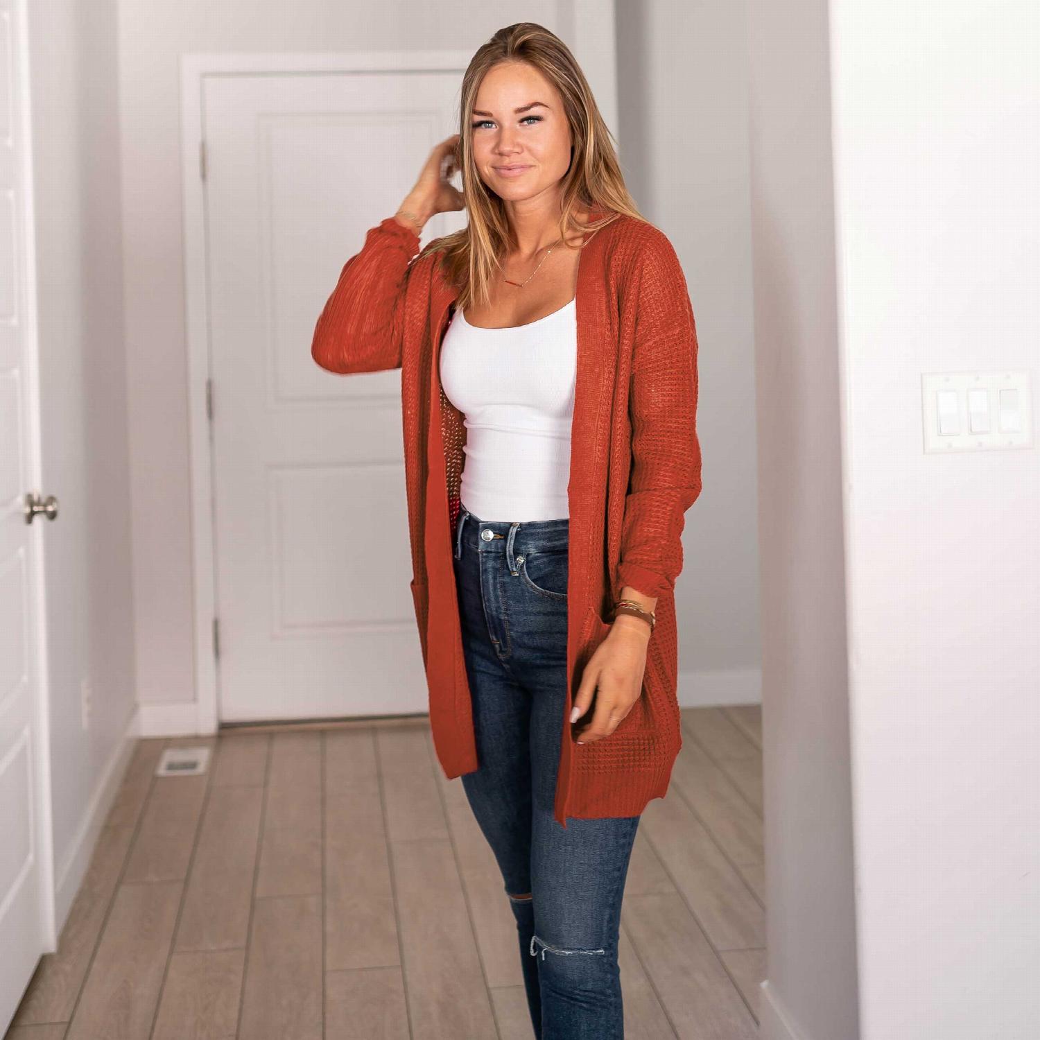 Waffle knit pocketed long sleeve cardigan sweater in a stylish open front design, featuring large pockets and a relaxed fit.