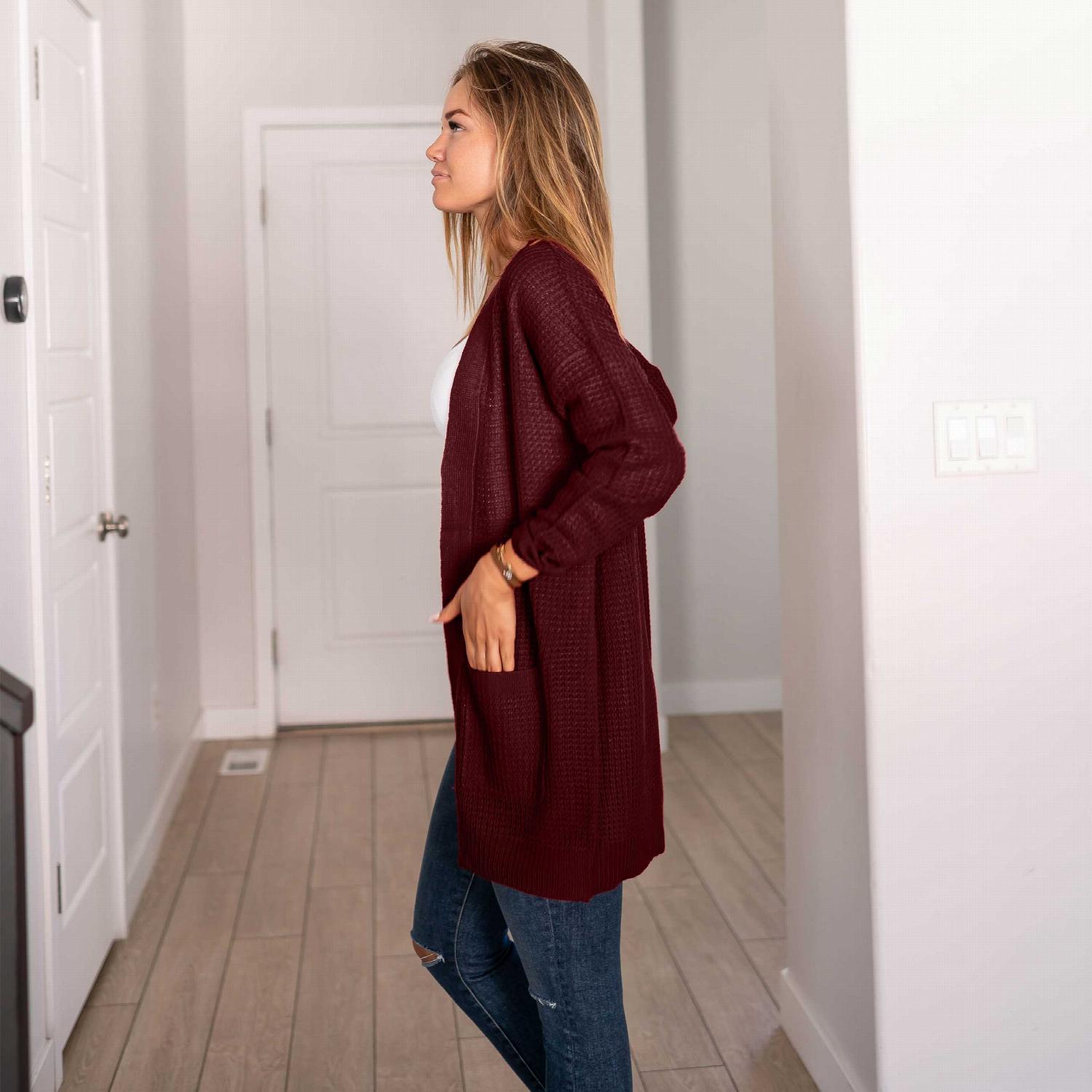 Waffle knit pocketed long sleeve cardigan sweater in a stylish open front design, featuring large pockets and a relaxed fit.