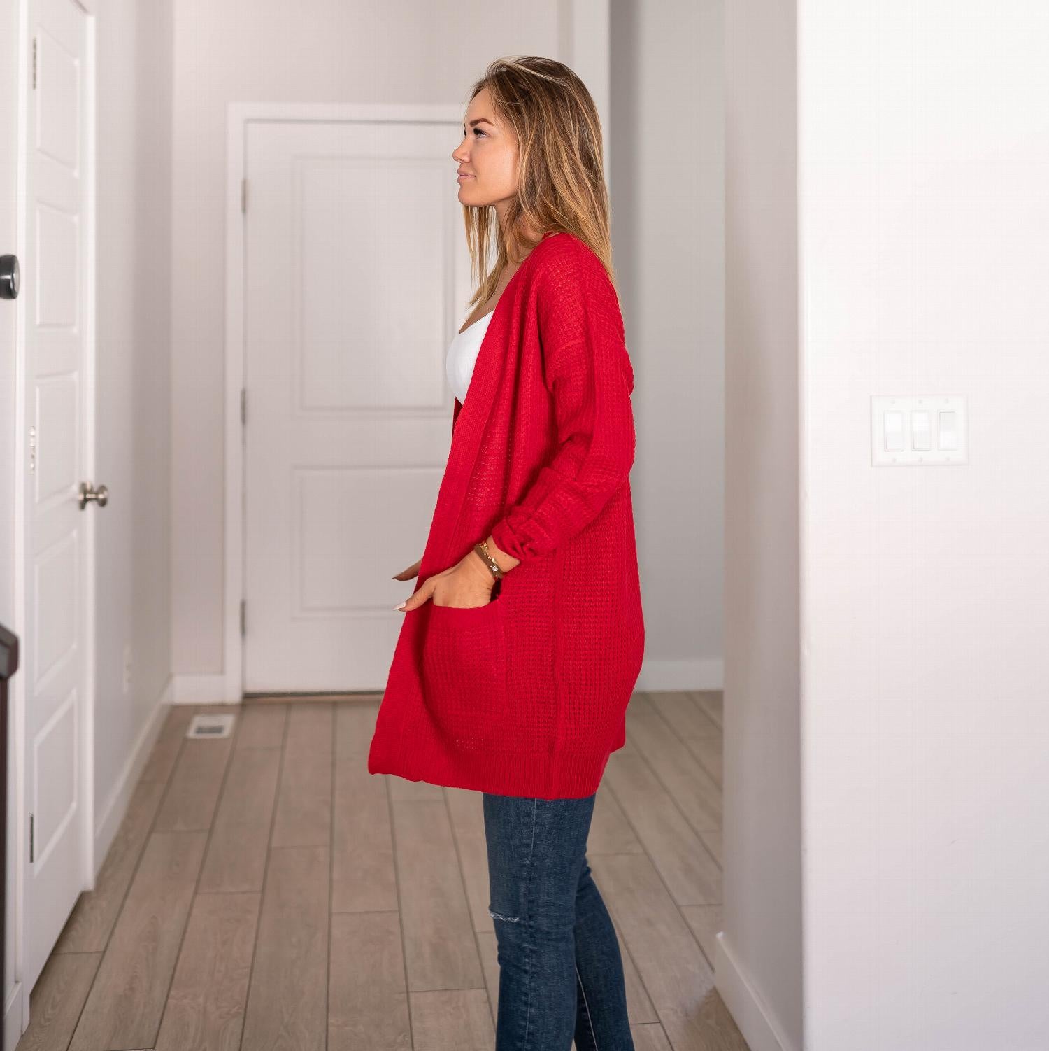 Waffle knit pocketed long sleeve cardigan sweater in a stylish open front design, featuring large pockets and a relaxed fit.