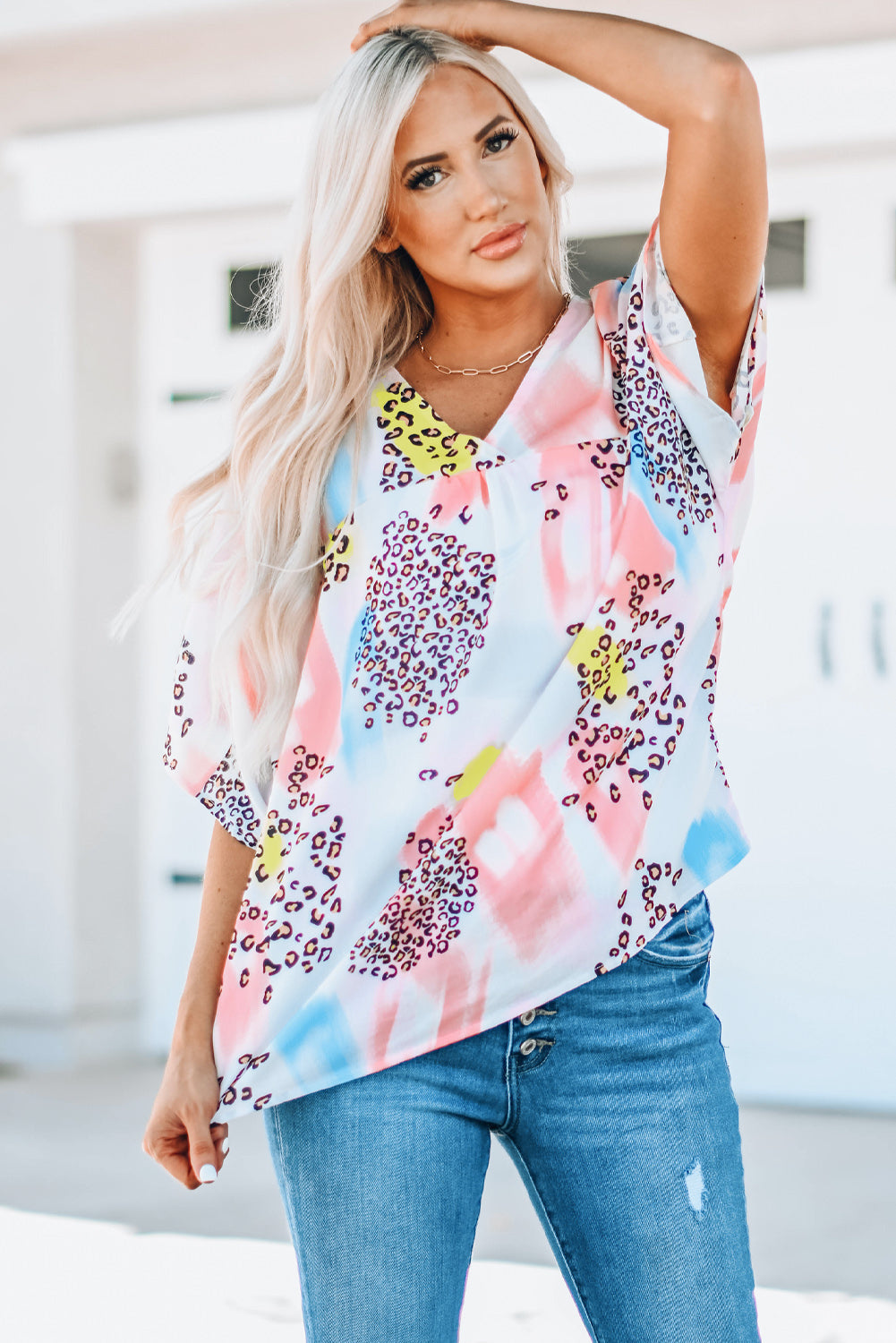 A vibrant Watercolor Print Loose Top featuring an oversized fit, v-neck design, and colorful animal print details, perfect for summer wear.