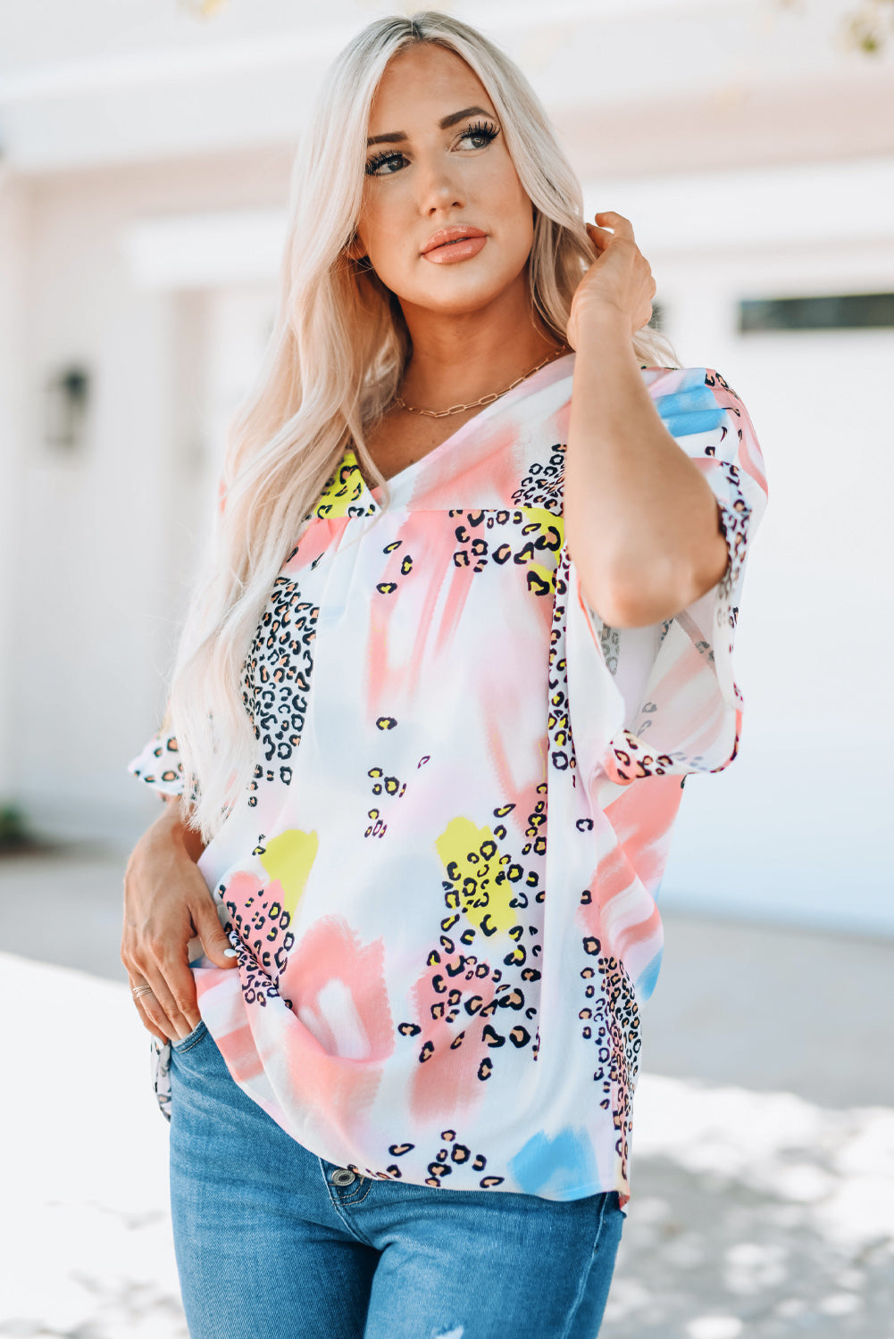 A vibrant Watercolor Print Loose Top featuring an oversized fit, v-neck design, and colorful animal print details, perfect for summer wear.