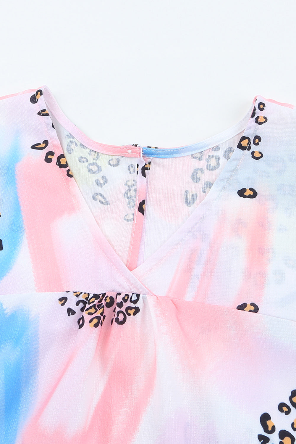 A vibrant Watercolor Print Loose Top featuring an oversized fit, v-neck design, and colorful animal print details, perfect for summer wear.