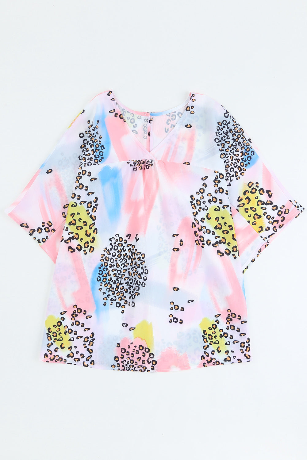 A vibrant Watercolor Print Loose Top featuring an oversized fit, v-neck design, and colorful animal print details, perfect for summer wear.