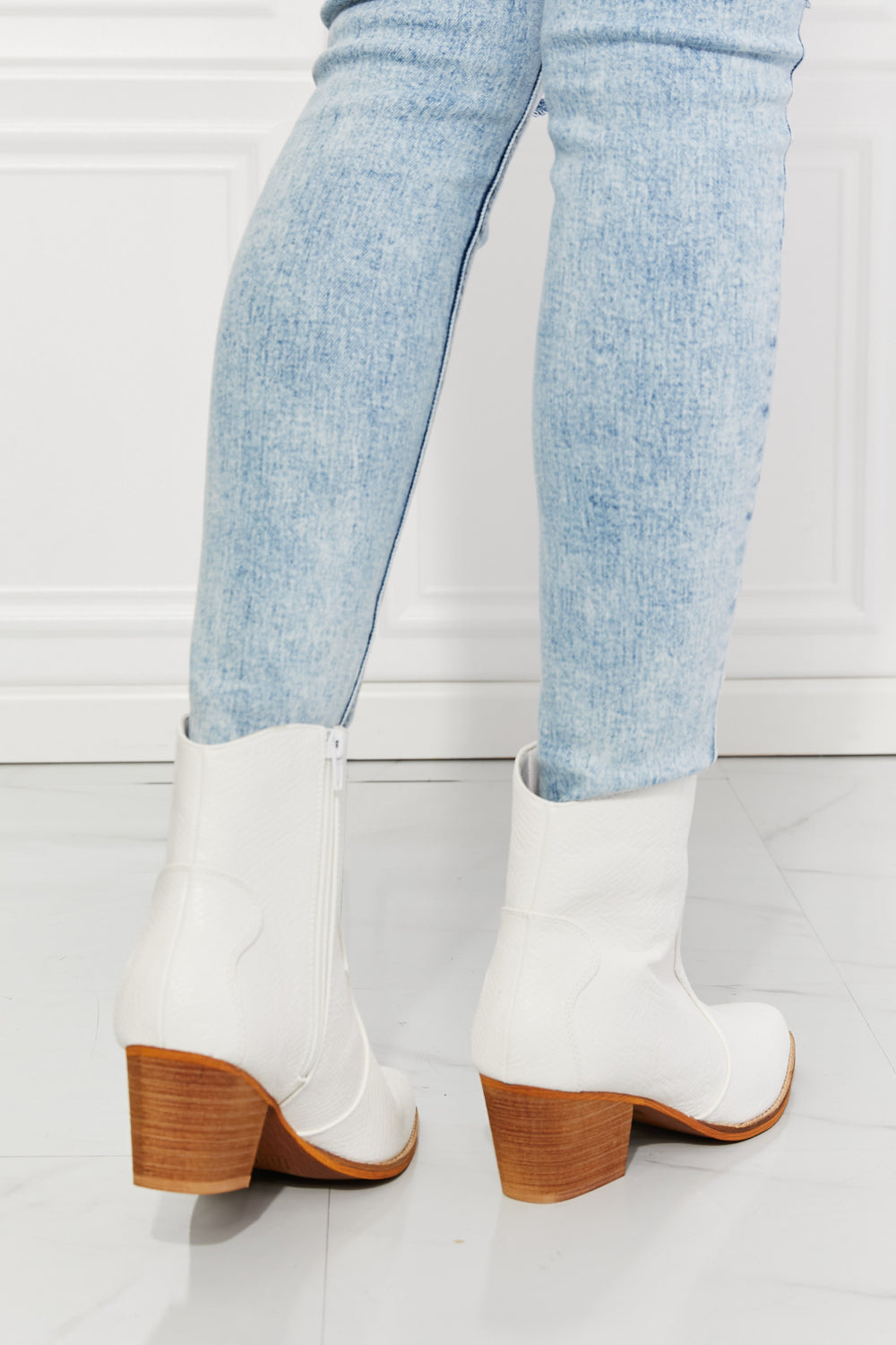 Watertower Town Faux Leather Western Ankle Boots in White with a pointed toe and stacked heel, showcasing a stylish design.