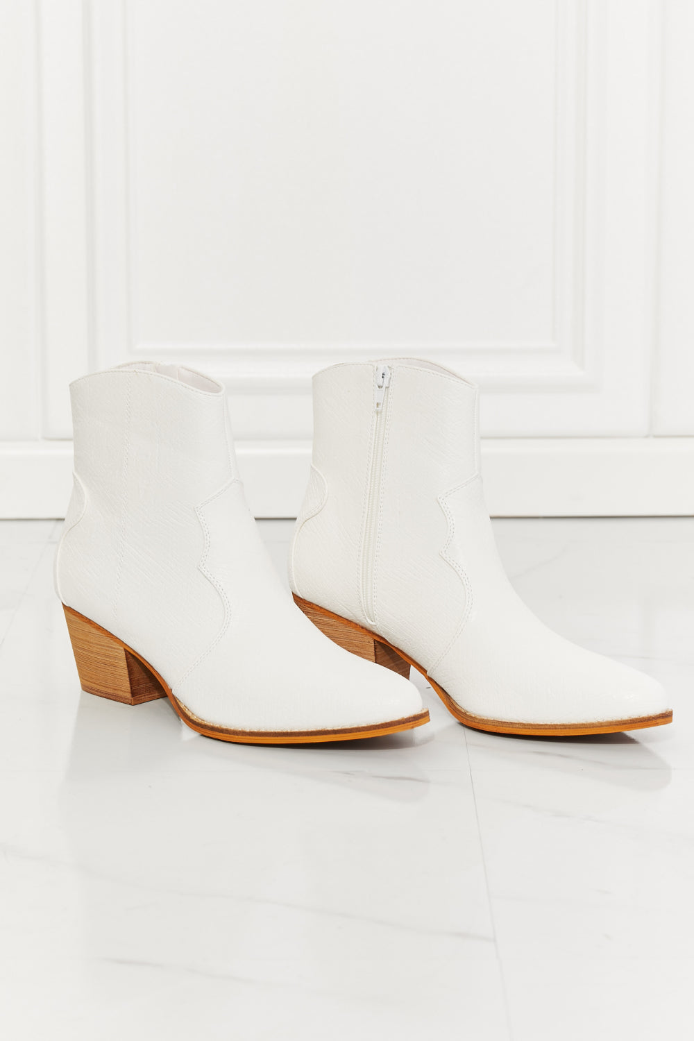 Watertower Town Faux Leather Western Ankle Boots in White with a pointed toe and stacked heel, showcasing a stylish design.