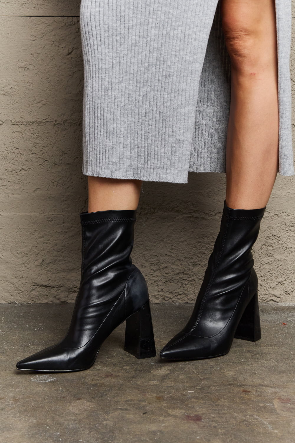 Weeboo Stacy Block Heel Sock Boots featuring a chic pointed toe and shiny block heel, designed for comfort and style.