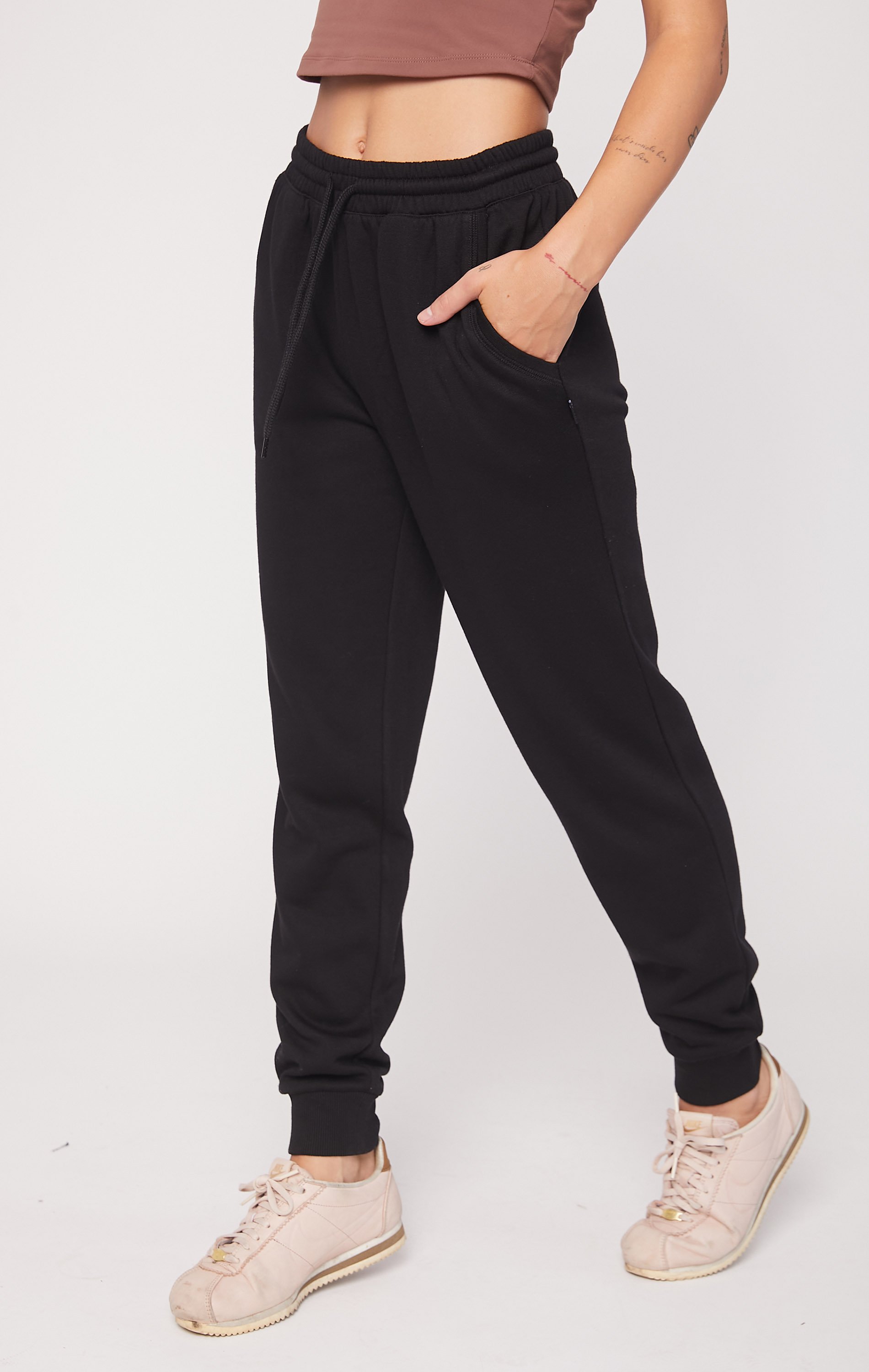 A pair of soft, plush fleece joggers in a cozy setting, featuring pockets and drawcords for a secure fit.