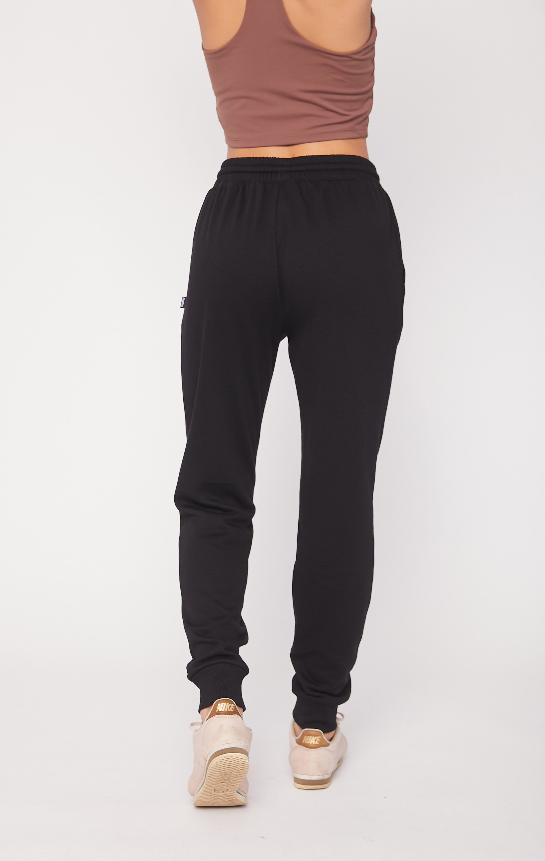 A pair of soft, plush fleece joggers in a cozy setting, featuring pockets and drawcords for a secure fit.