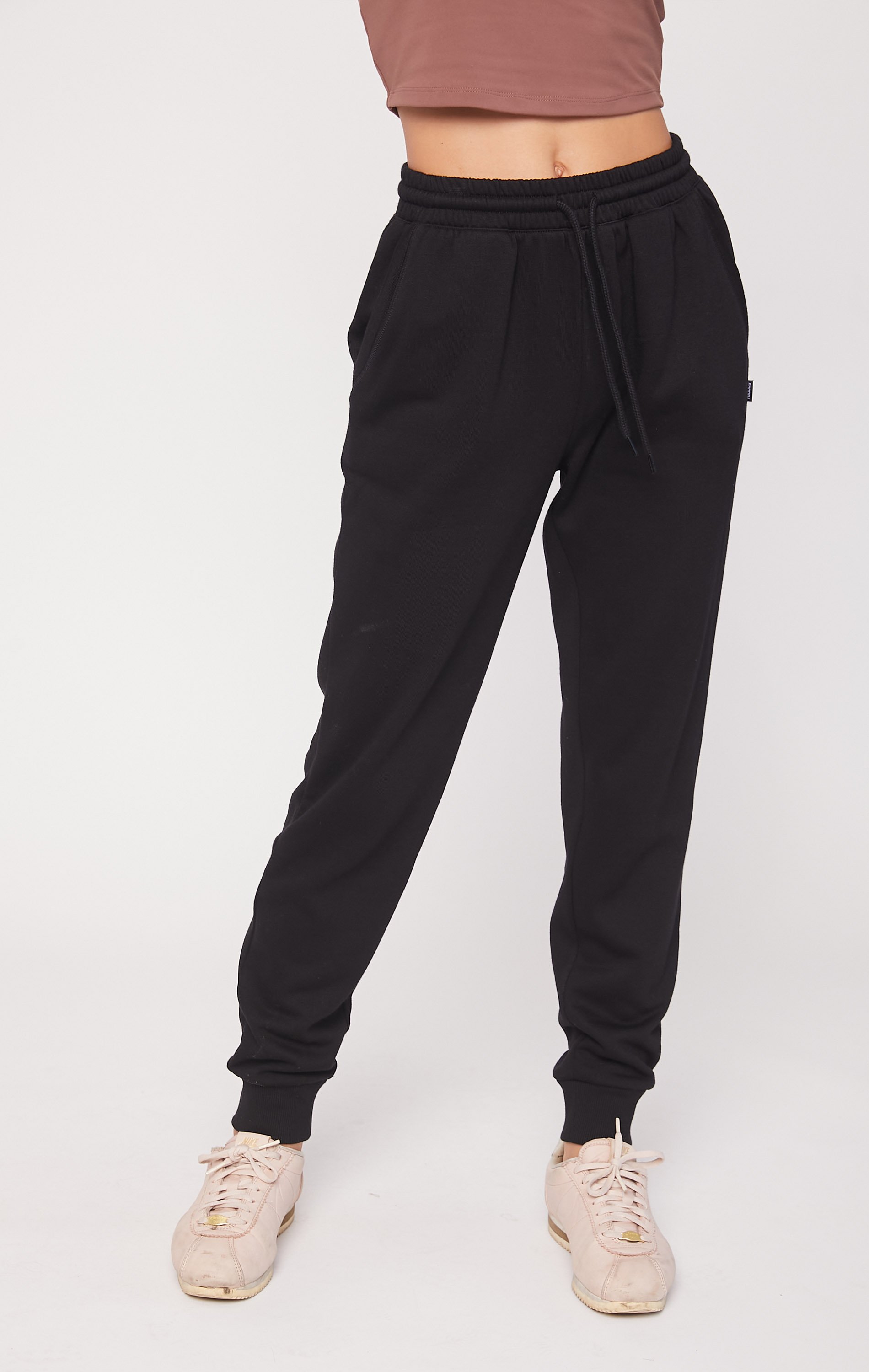 A pair of soft, plush fleece joggers in a cozy setting, featuring pockets and drawcords for a secure fit.