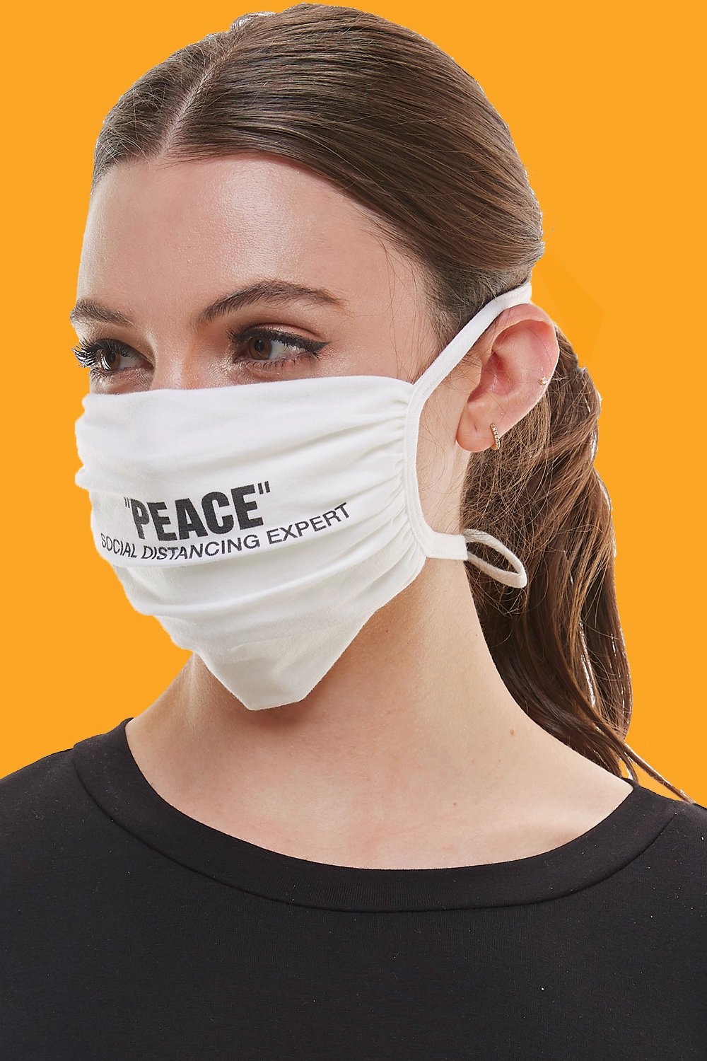 White adjustable tie face mask made of washable cotton fabric, featuring four tie-up straps and an inner pocket for filters.
