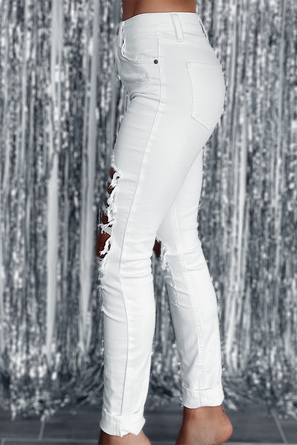 White distressed ripped holes high waist skinny jeans showcasing trendy design and slim fit.