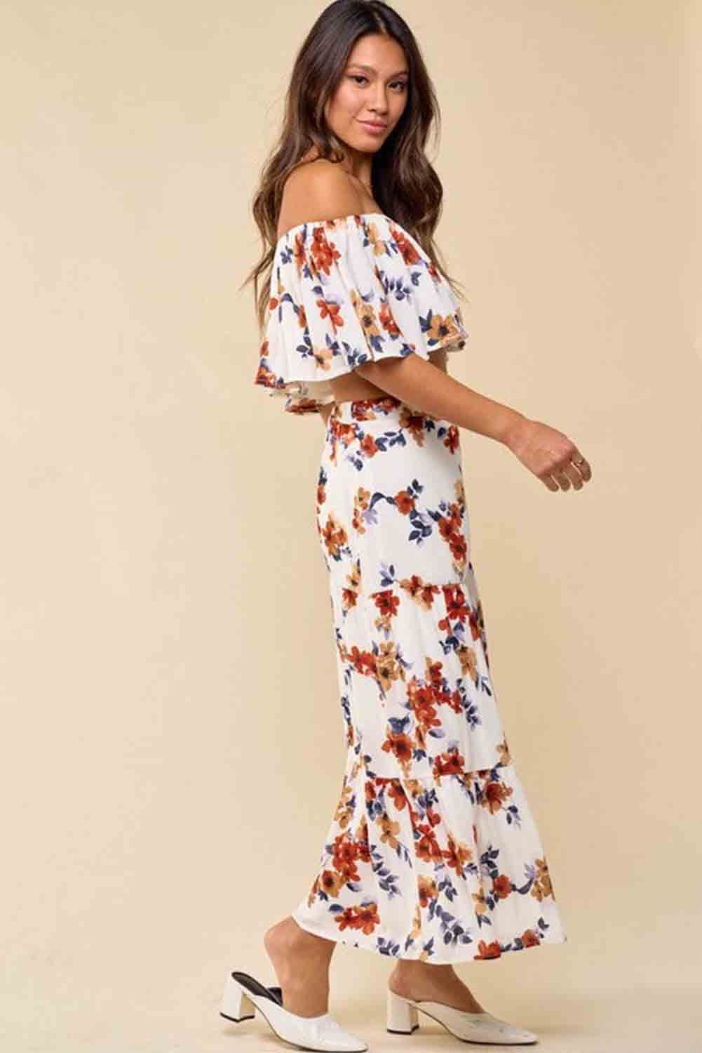 A stylish white floral print off-shoulder crop top paired with a flowing maxi skirt featuring a high slit, perfect for summer outings.