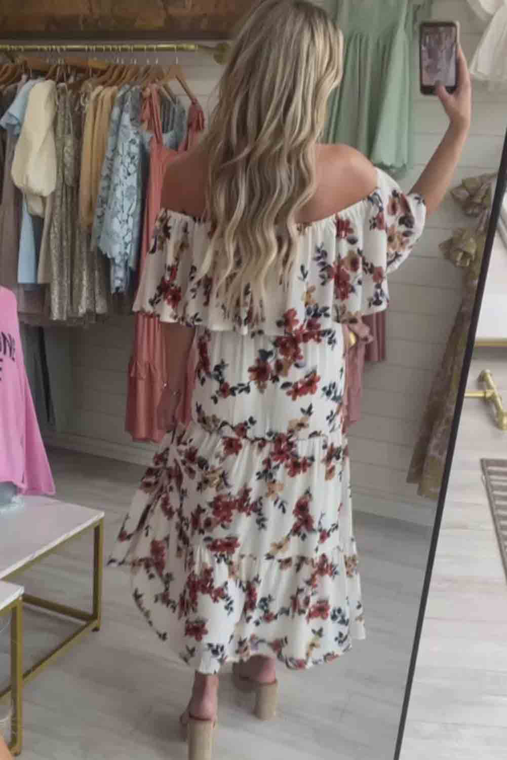 A stylish white floral print off-shoulder crop top paired with a flowing maxi skirt featuring a high slit, perfect for summer outings.