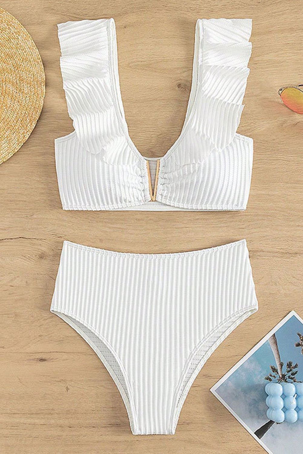White textured bikini set featuring ruffled details and a notched V-neckline, perfect for beach outings.