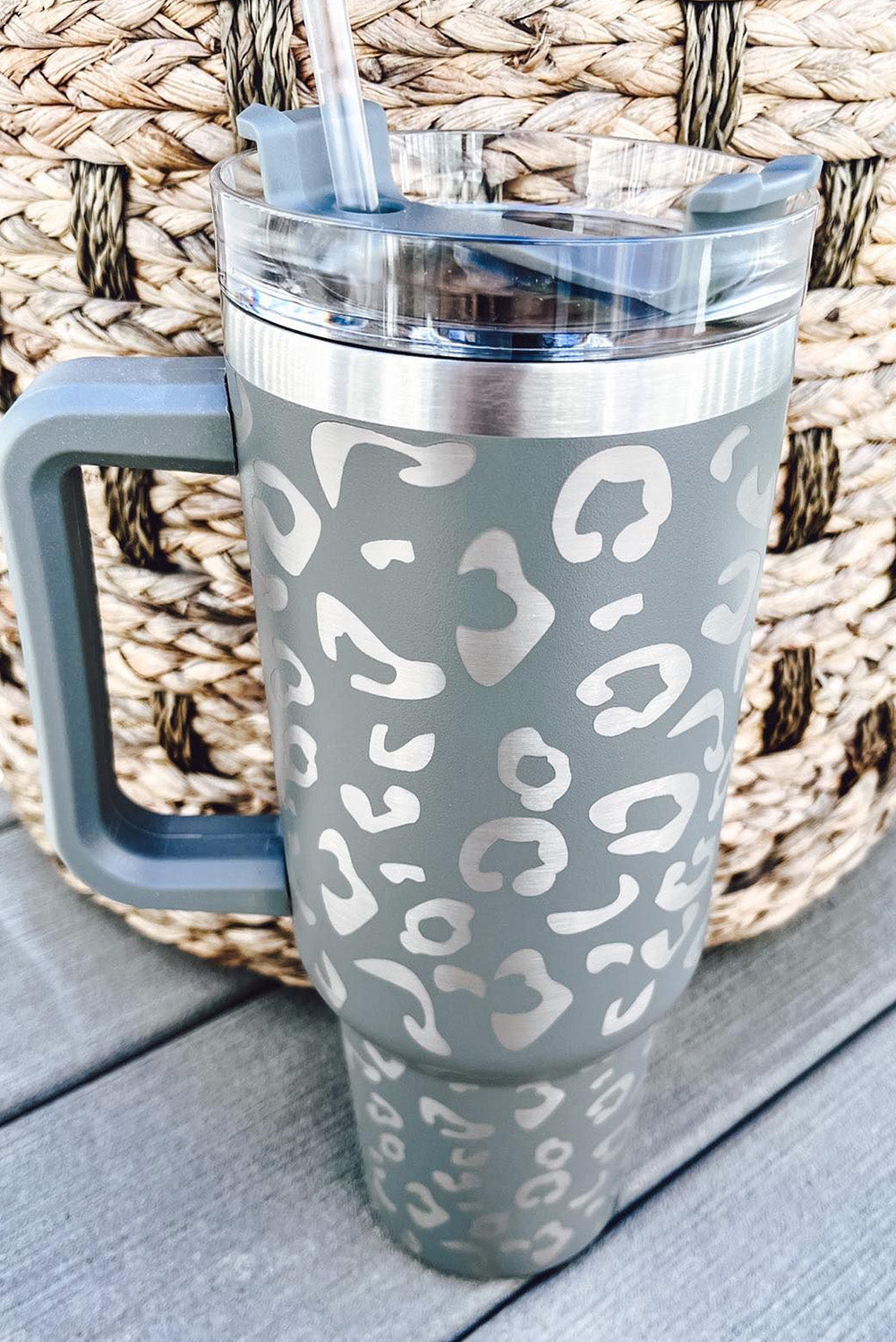 Three leopard spotted 40oz stainless steel double insulated cups, showcasing their stylish design and durable construction.