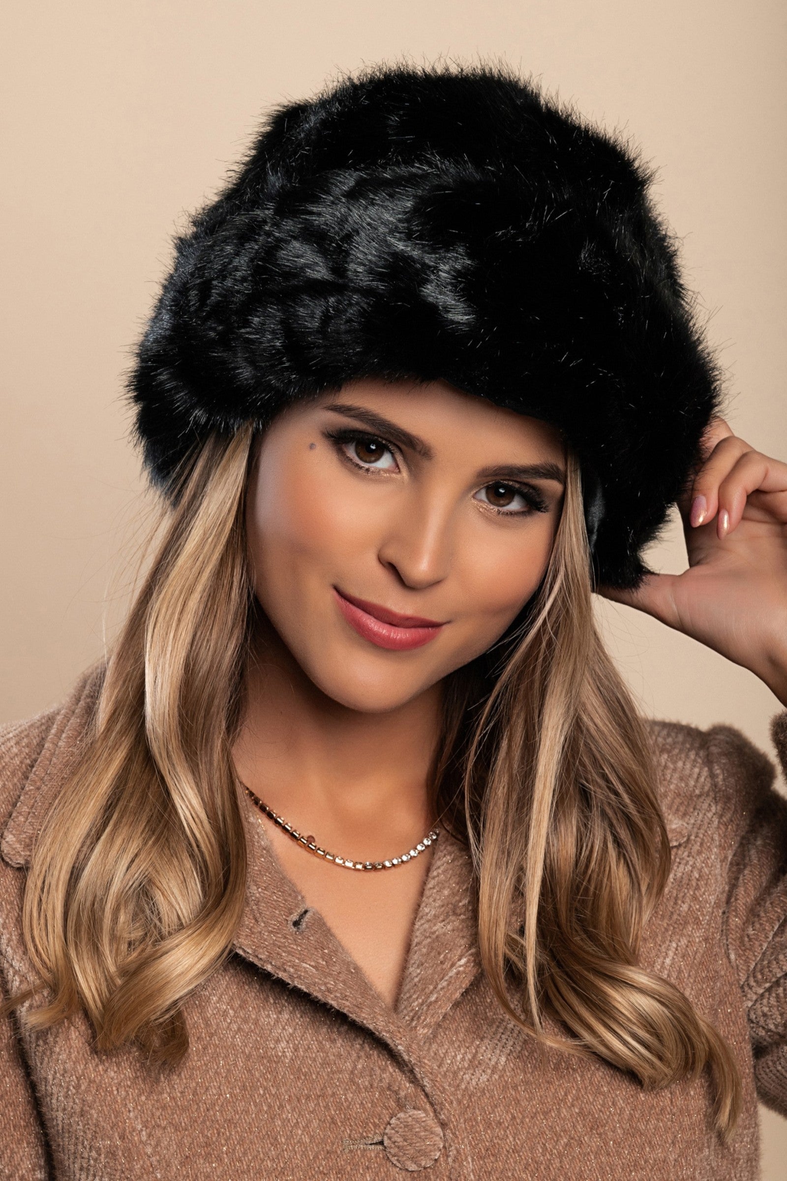 Elegant black winter hat with soft synthetic fur lining, perfect for cold weather.
