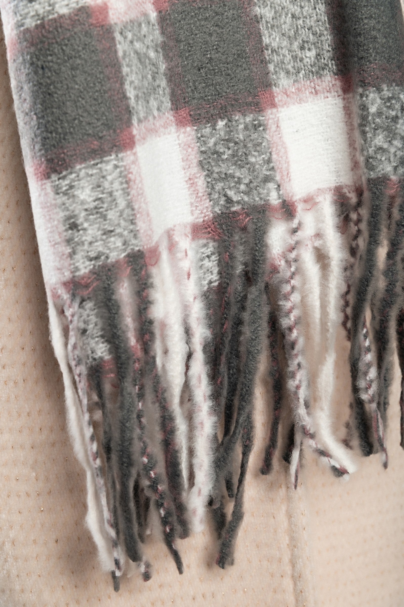 Gray winter scarf featuring a stylish checkered print, made from a soft viscose and wool blend.