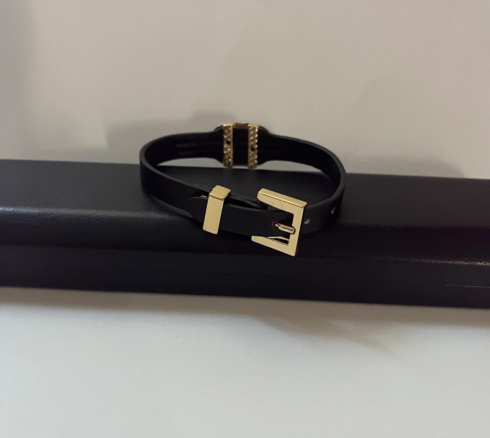 Elegant Gucci Women Bracelet made of genuine leather in gold and black colors, showcasing a stylish design.