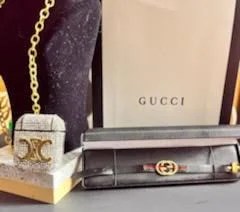 Elegant Gucci Women Bracelet made of genuine leather in gold and black colors, showcasing a stylish design.