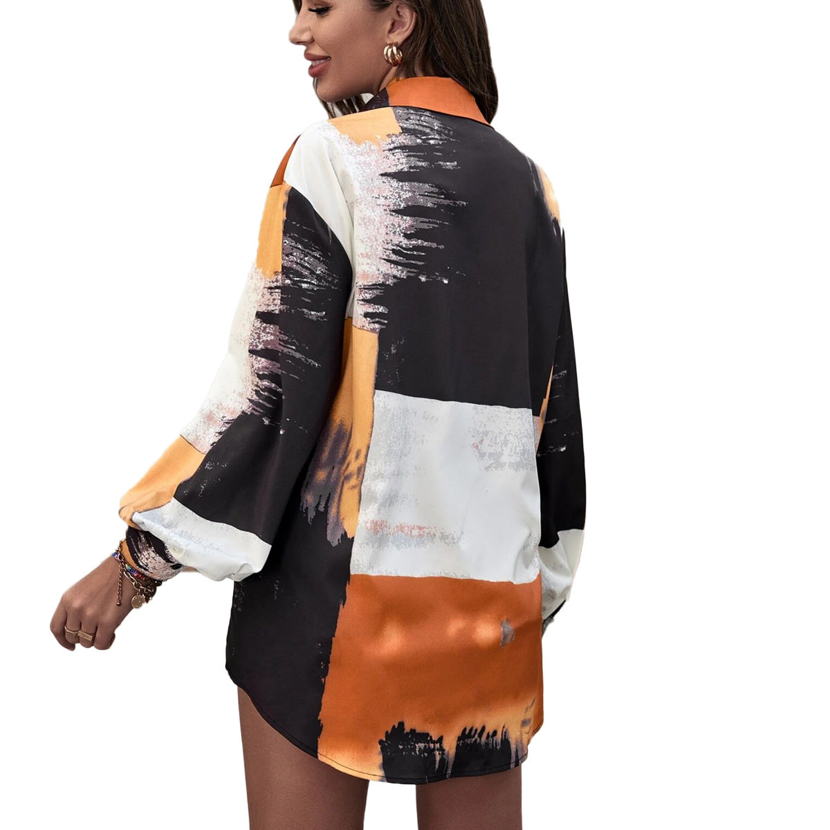 A stylish women's long sleeve printed shirt featuring a geometric pattern, designed for autumn and winter wear, showcasing its loose fit and shirt collar.