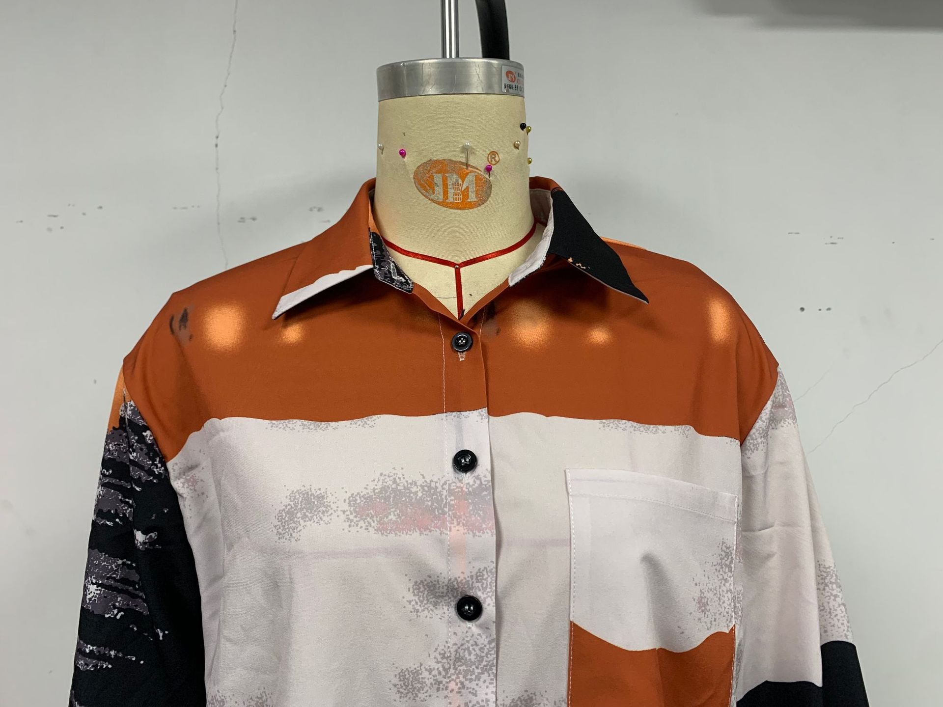 A stylish women's long sleeve printed shirt featuring a geometric pattern, designed for autumn and winter wear, showcasing its loose fit and shirt collar.