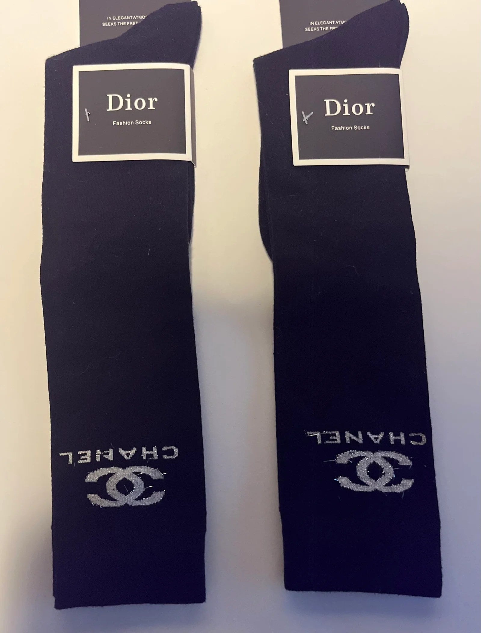 A pair of Women's High Knee Socks in a cozy fabric, designed to rest just below the knee, perfect for wearing with boots or lounging at home.