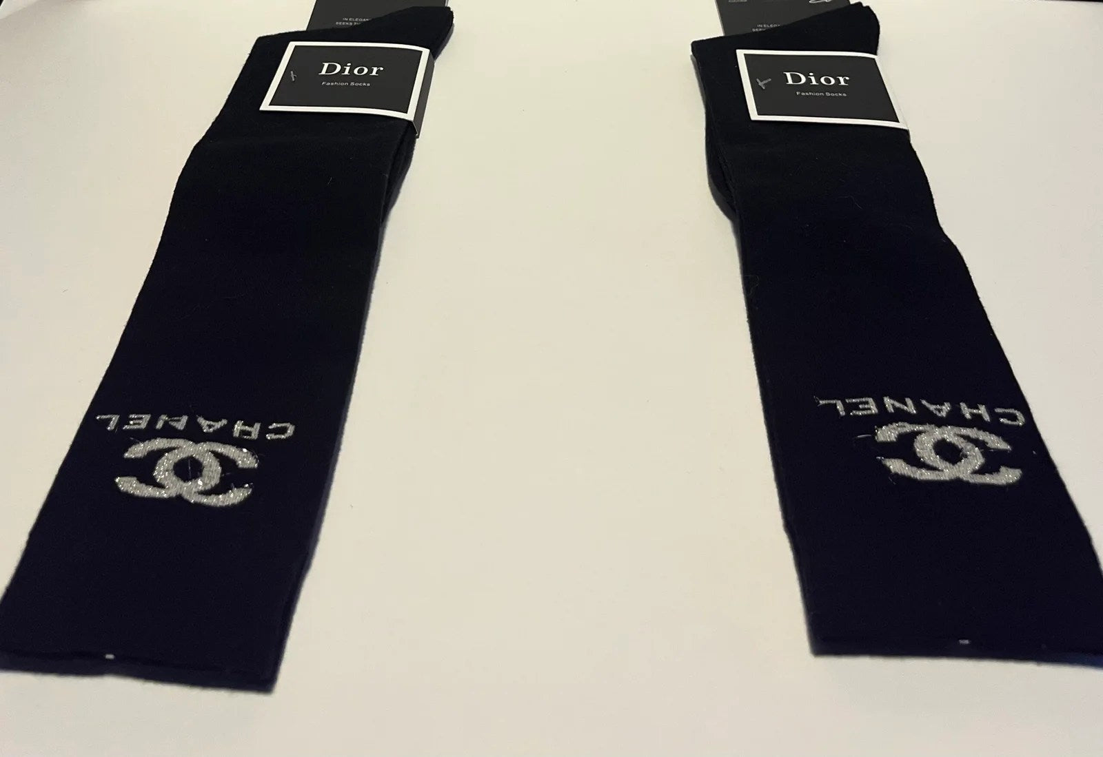 A pair of Women's High Knee Socks in a cozy fabric, designed to rest just below the knee, perfect for wearing with boots or lounging at home.