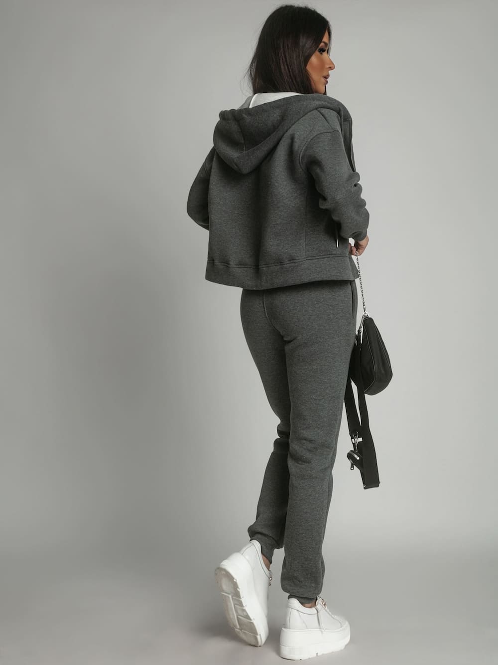 Women's insulated tracksuit set in graphite color, featuring a zipped hoodie and elastic waist trousers, perfect for winter wear.
