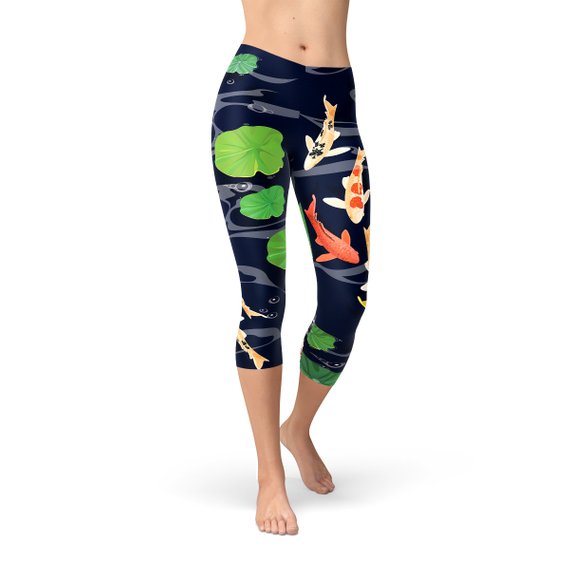 Women's capri leggings featuring a vibrant koi fish design in a serene pond setting, perfect for workouts and casual wear.