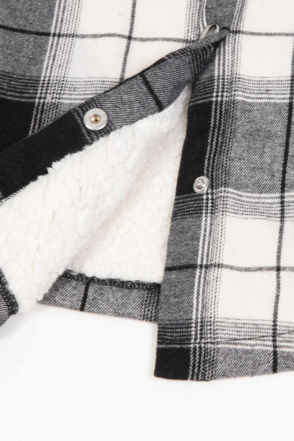Women's black and white snap-up flannel shacket with sherpa lining, perfect for outdoor activities and family matching.