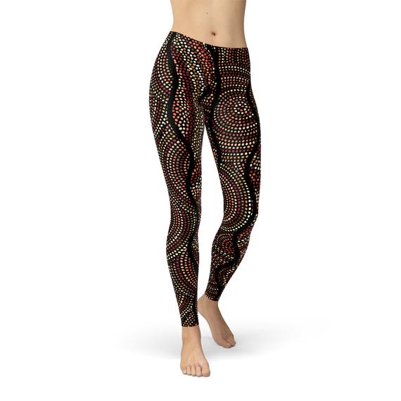 Women's leggings featuring polka dots and Aboriginal artwork inspired by Dreamtime, showcasing vibrant colors and a comfortable fit.
