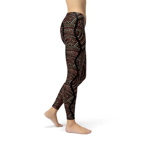 Women's leggings featuring polka dots and Aboriginal artwork inspired by Dreamtime, showcasing vibrant colors and a comfortable fit.