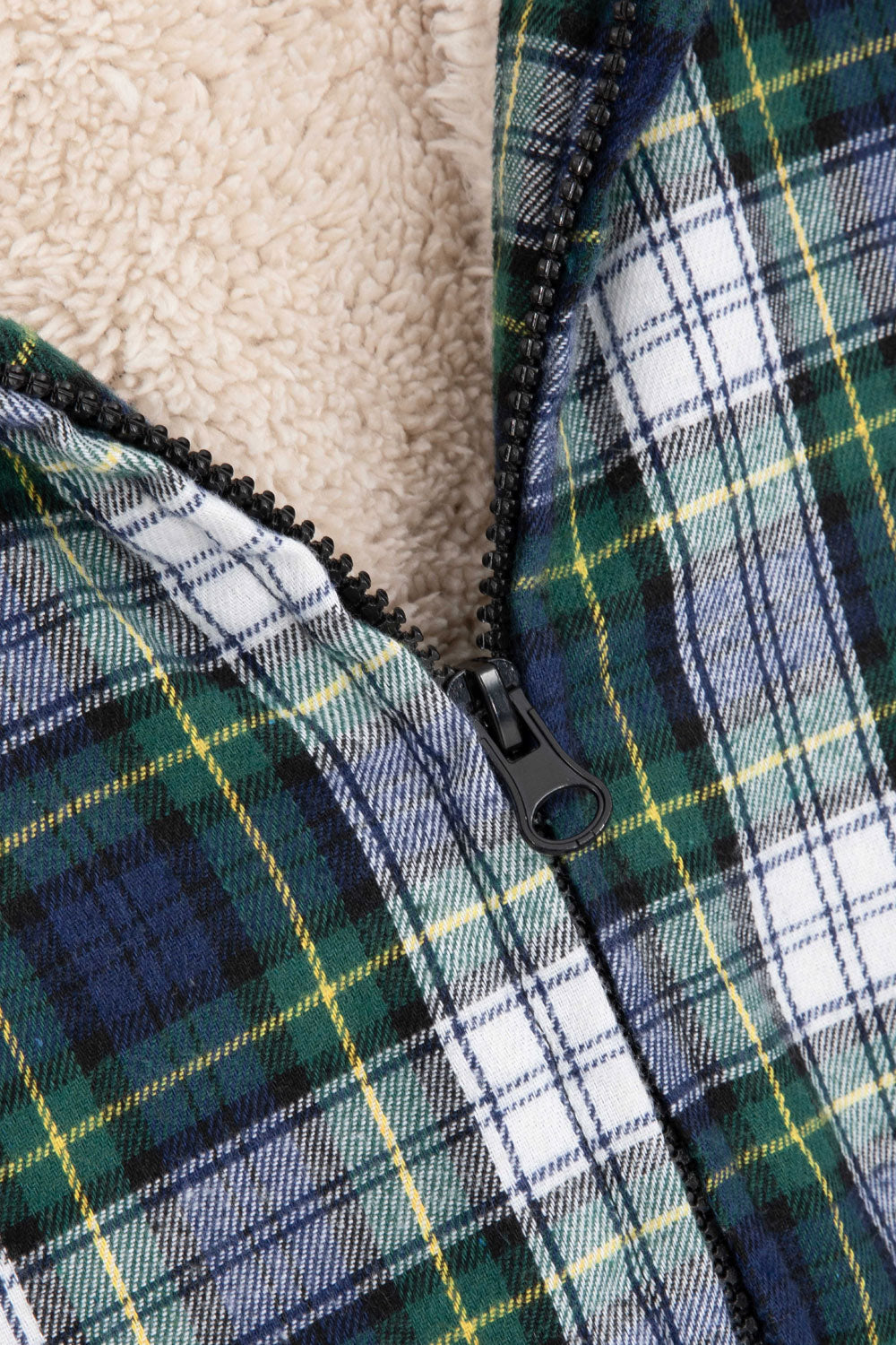 Women's sherpa-lined flannel jacket with a full zip-up design, featuring a hood and plaid pattern, perfect for chilly weather.