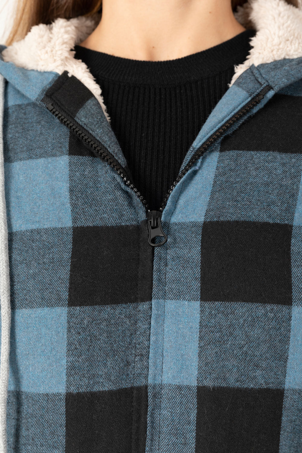 Women's sherpa-lined flannel jacket with a full zip-up design, featuring a hood and plaid pattern, perfect for chilly weather.