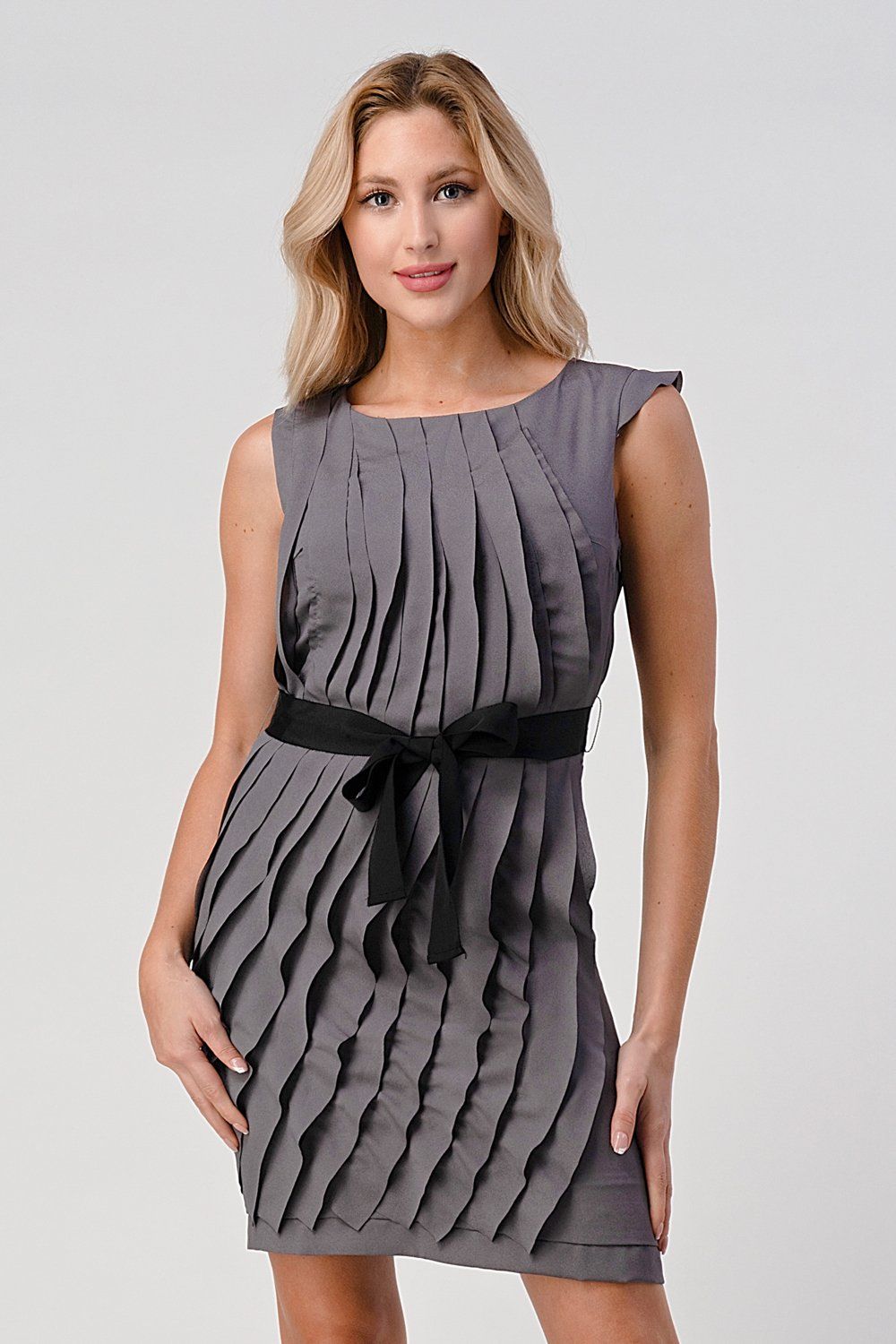 Women's sleeveless pleated shift dress with waist tie, showcasing elegant design and stylish silhouette.