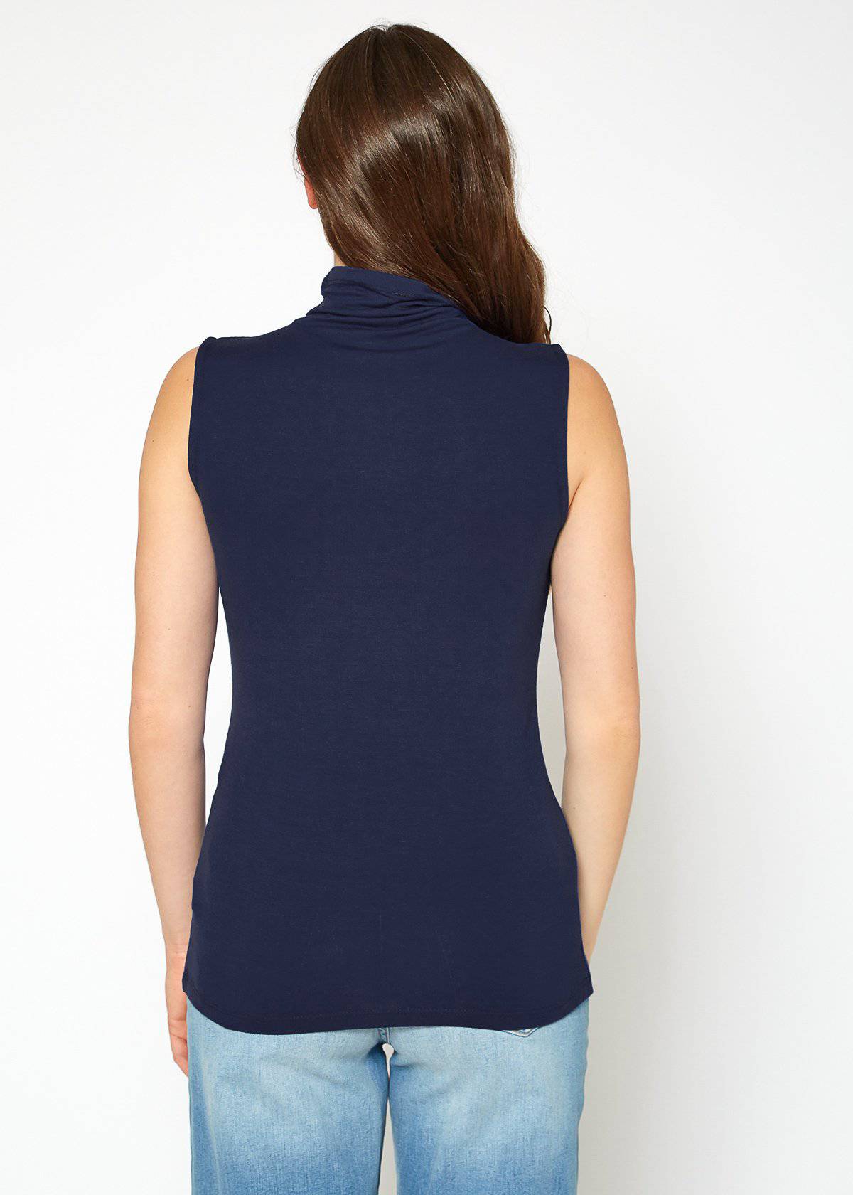 A stylish Women's Sleeveless Turtle Neck Fitted Top in a soft fabric, perfect for layering in fall and winter.