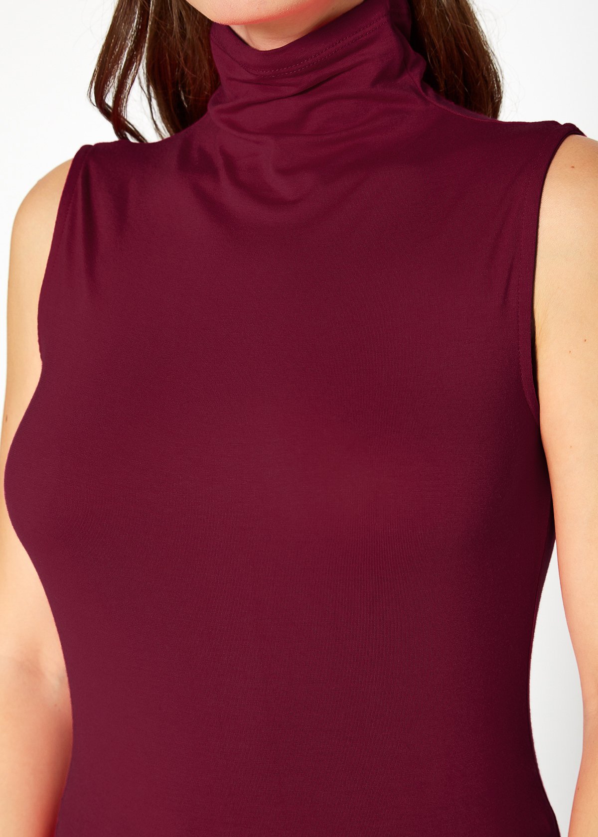 A stylish Women's Sleeveless Turtle Neck Fitted Top in a soft fabric, perfect for layering in fall and winter.