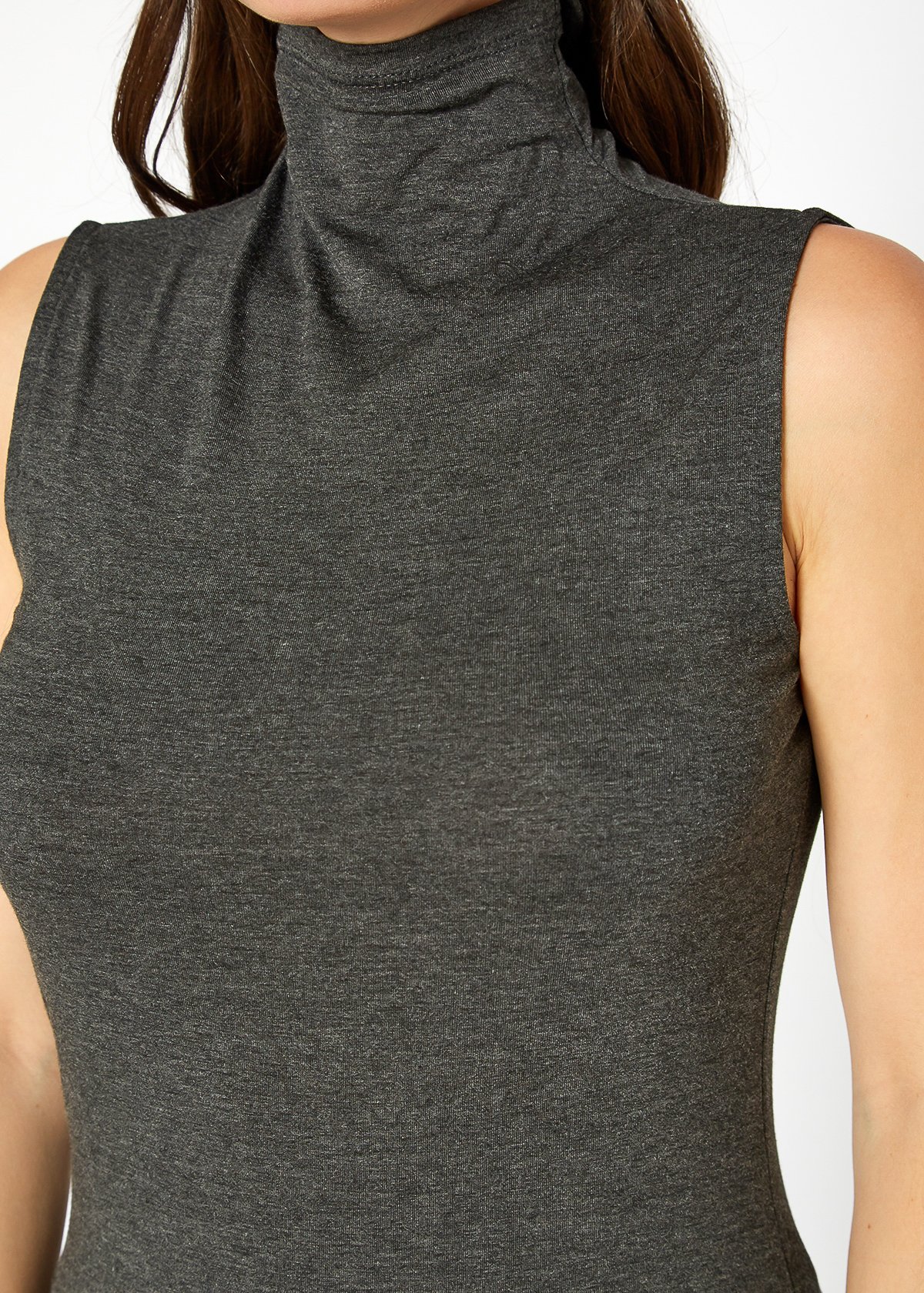 A stylish Women's Sleeveless Turtle Neck Fitted Top in a soft fabric, perfect for layering in fall and winter.