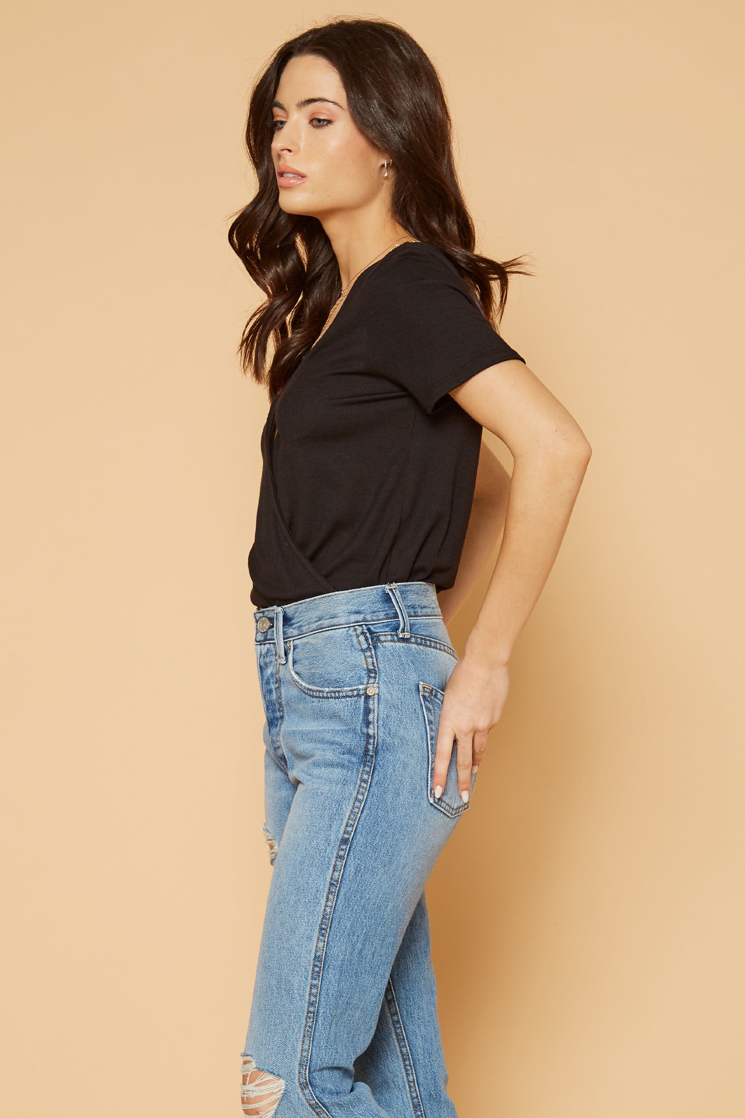 Women's V-Neck Short Sleeve Surplus Bodysuit in Black with front wrap detail, showcasing its stylish design and comfortable fit.