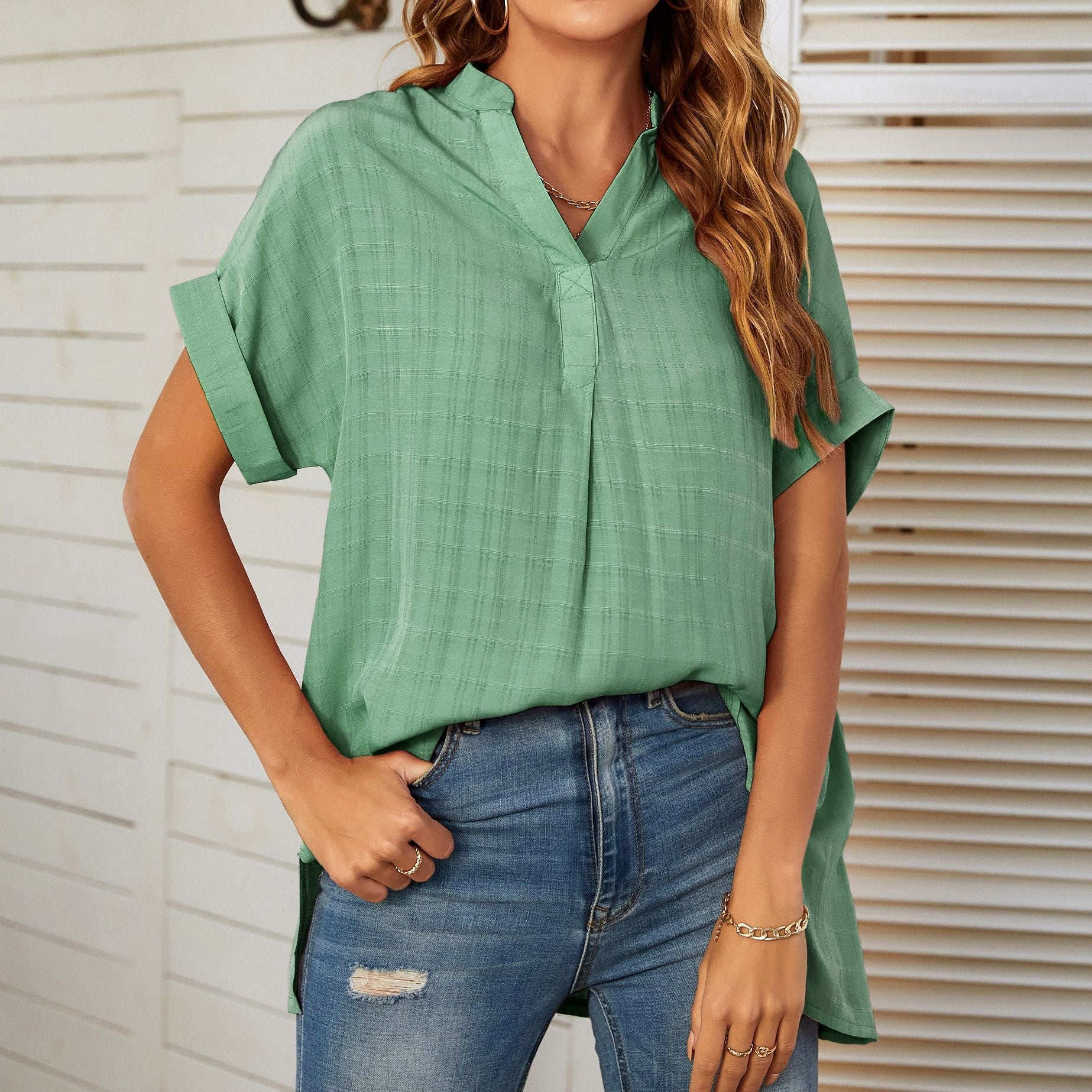 A stylish Women's V-Neck Short Sleeve Solid Color Thin Loose Check Shirt displayed on a mannequin, showcasing its elegant design and comfortable fit.