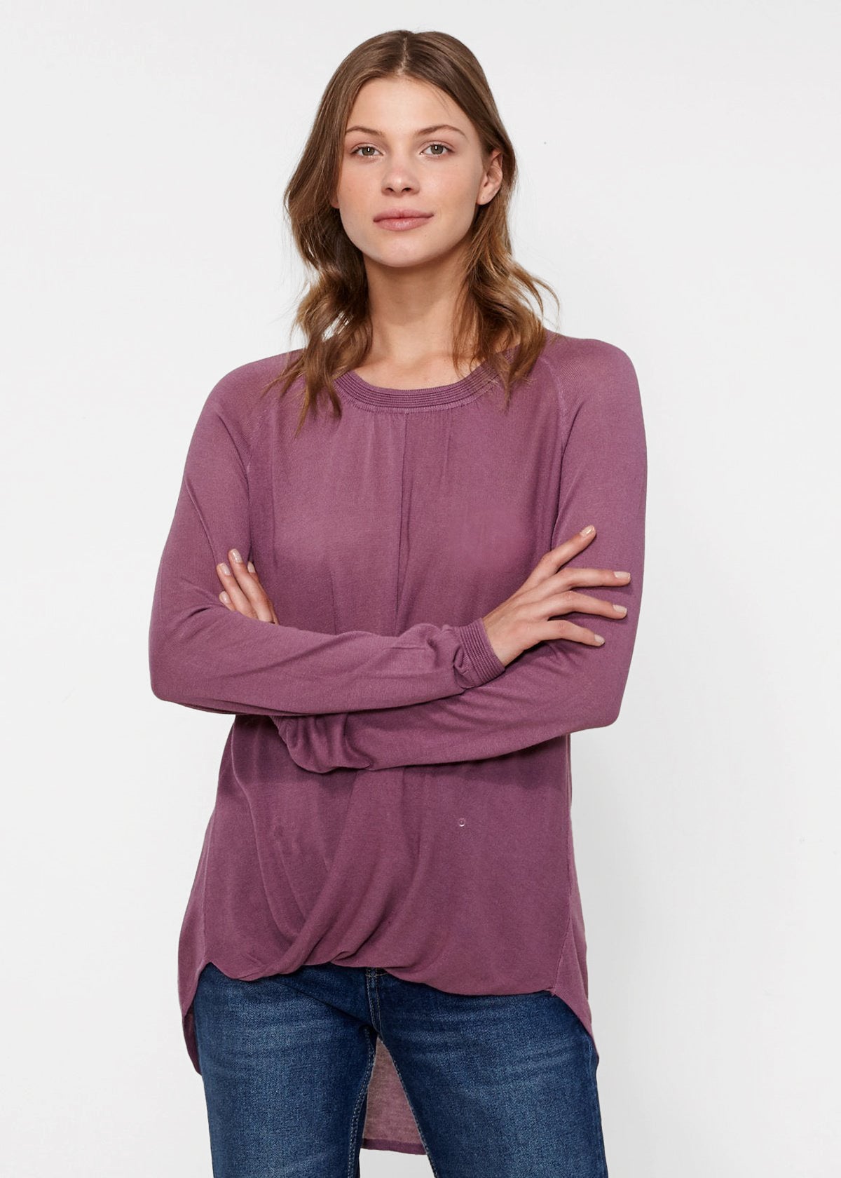 Person wearing purple long-sleeved top.