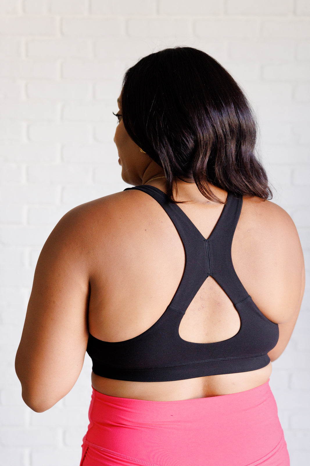 Black Working Out My Ego Cross Back Sports Bra featuring a square neckline and stylish back cutout, made from soft brushed microfiber.